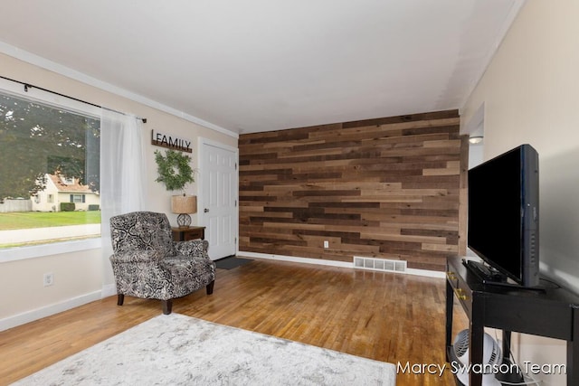 4172 Ranchero Dr, Dorr, MI 49323 - living area featuring wooden walls, wood finished floors, and crown molding