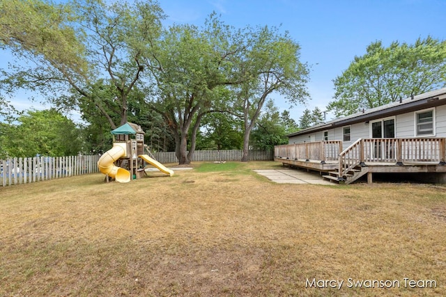 4172 Ranchero Dr, Dorr, MI 49323 - fenced backyard featuring a deck and a playground