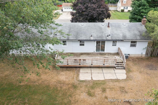 4172 Ranchero Dr, Dorr, MI 49323 - rear view of house featuring a wooden deck, a yard, a chimney, and roof with shingles