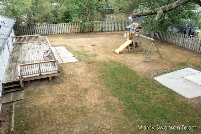 4172 Ranchero Dr, Dorr, MI 49323 - fenced backyard featuring a playground and a deck