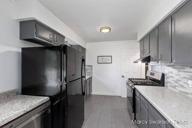 4172 Ranchero Dr, Dorr, MI 49323 - kitchen featuring appliances with stainless steel finishes, backsplash, under cabinet range hood, dark tile patterned flooring, and gray cabinetry