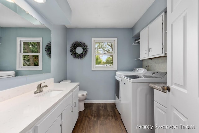 4172 Ranchero Dr, Dorr, MI 49323 - laundry area featuring separate washer and dryer, healthy amount of natural light, and dark wood-style floors
