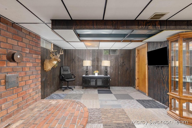 4172 Ranchero Dr, Dorr, MI 49323 - finished below grade area with wood walls, brick wall, and carpet