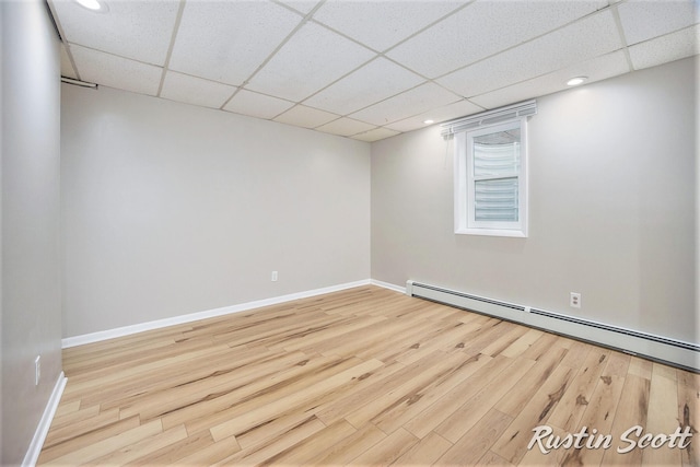 2953-2955 Okemos Dr SE, Grand Rapids, MI 49546 - empty room featuring a baseboard heating unit, wood finished floors, a paneled ceiling, and recessed lighting