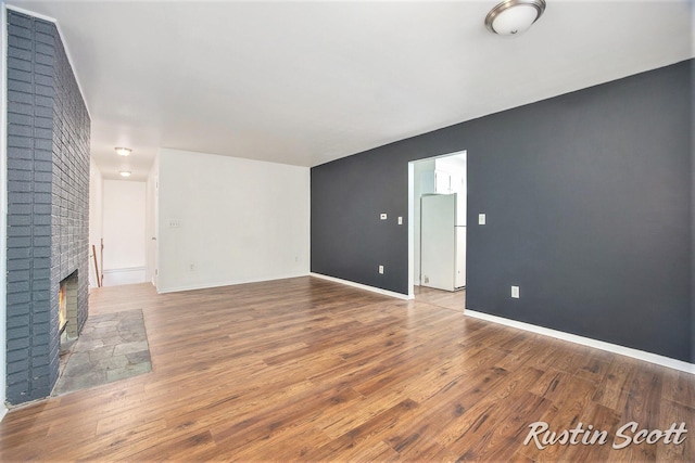 2953-2955 Okemos Dr SE, Grand Rapids, MI 49546 - unfurnished living room featuring wood finished floors and a fireplace