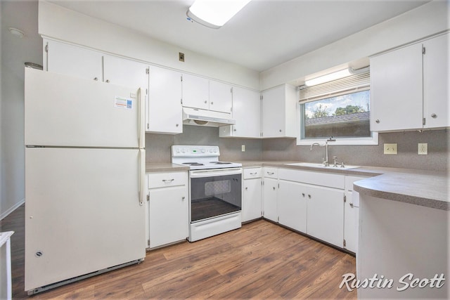2953-2955 Okemos Dr SE, Grand Rapids, MI 49546 - kitchen featuring white appliances, under cabinet range hood, white cabinetry, dark wood-style floors, and light countertops