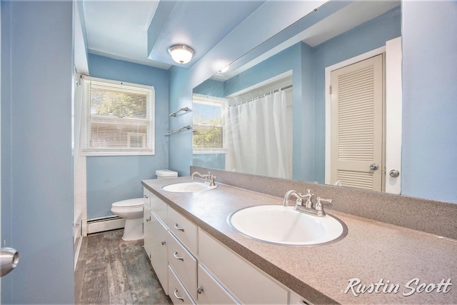 2953-2955 Okemos Dr SE, Grand Rapids, MI 49546 - bathroom with a baseboard heating unit, double vanity, wood finished floors, and a shower with curtain
