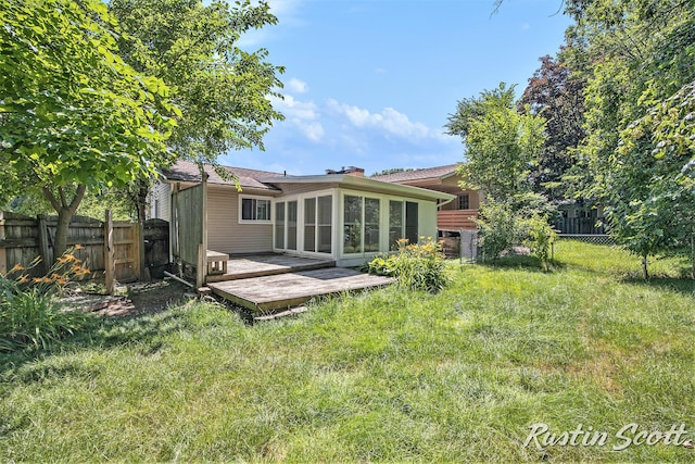 2953-2955 Okemos Dr SE, Grand Rapids, MI 49546 - back of house featuring a wooden deck, a fenced backyard, and a sunroom