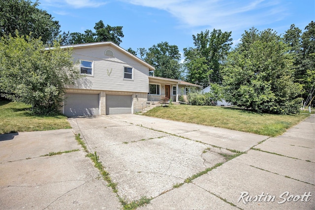 2953-2955 Okemos Dr SE, Grand Rapids, MI 49546 - tri-level home with a front lawn, a garage, concrete driveway, and brick siding
