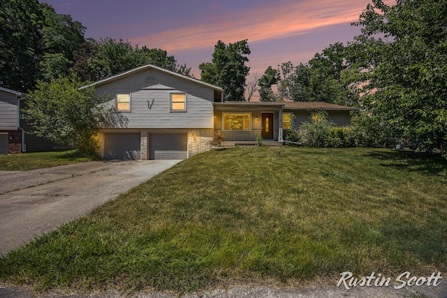 2953-2955 Okemos Dr SE, Grand Rapids, MI 49546 - tri-level home with an attached garage, covered porch, a yard, and driveway
