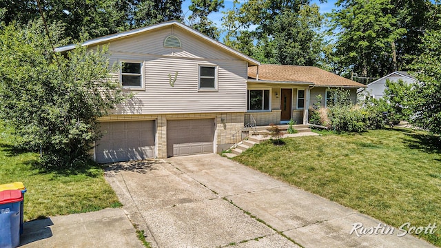 2953-2955 Okemos Dr SE, Grand Rapids, MI 49546 - tri-level home with an attached garage, a front lawn, concrete driveway, and brick siding
