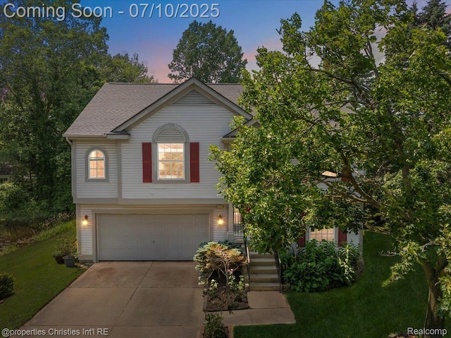 6873 Fox Ln, Waterford, MI 48327 - view of front of house with an attached garage, concrete driveway, a yard, and roof with shingles