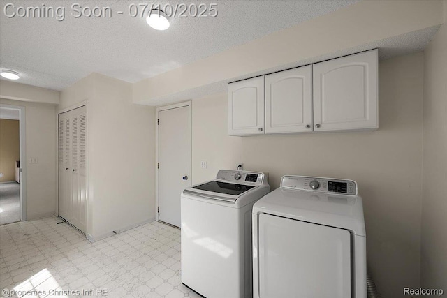 6873 Fox Ln, Waterford, MI 48327 - washroom with light floors, washing machine and clothes dryer, cabinet space, and a textured ceiling