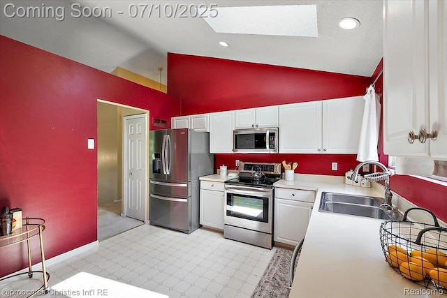 6873 Fox Ln, Waterford, MI 48327 - kitchen featuring appliances with stainless steel finishes, high vaulted ceiling, white cabinets, light countertops, and light flooring