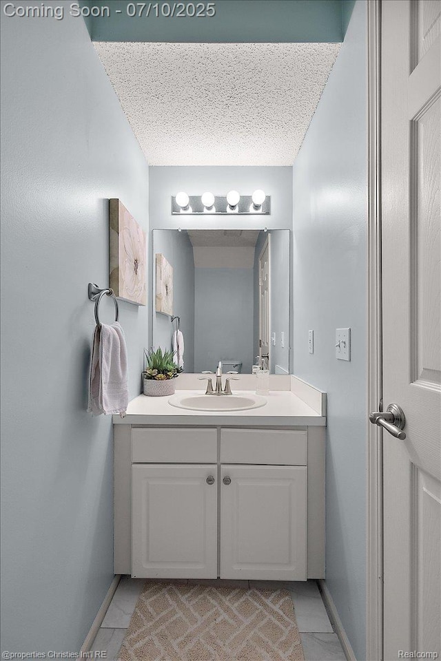 6873 Fox Ln, Waterford, MI 48327 - bathroom featuring vanity, tile patterned flooring, and a textured ceiling
