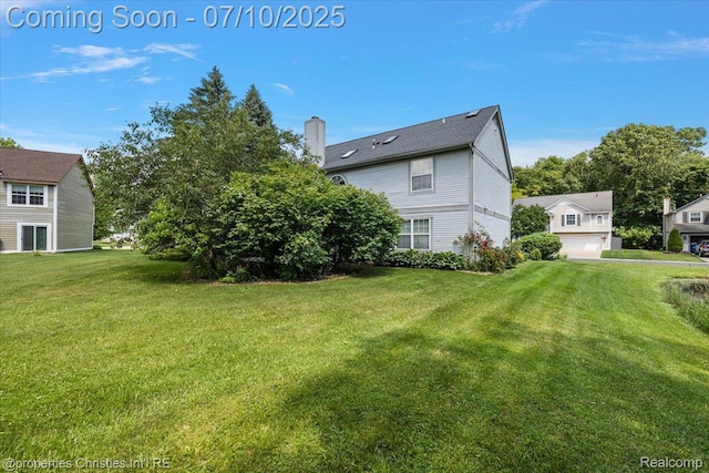 6873 Fox Ln, Waterford, MI 48327 - view of property exterior with a chimney, a lawn, and a garage