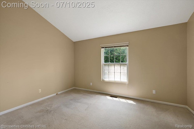 6873 Fox Ln, Waterford, MI 48327 - spare room featuring light colored carpet and vaulted ceiling