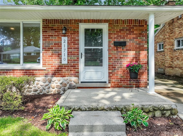 21710 Whitmore St, Oak Park, MI 48237 - view of exterior entry with covered porch and brick siding
