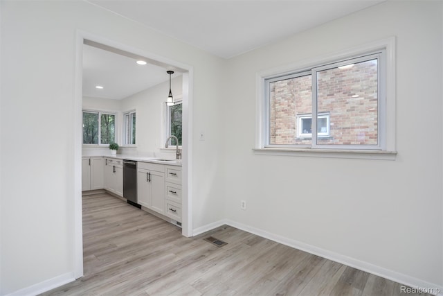 21710 Whitmore St, Oak Park, MI 48237 - kitchen featuring stainless steel dishwasher, white cabinets, light wood-type flooring, light countertops, and recessed lighting