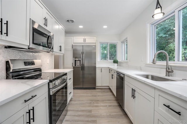 21710 Whitmore St, Oak Park, MI 48237 - kitchen with appliances with stainless steel finishes, plenty of natural light, recessed lighting, and light wood-type flooring