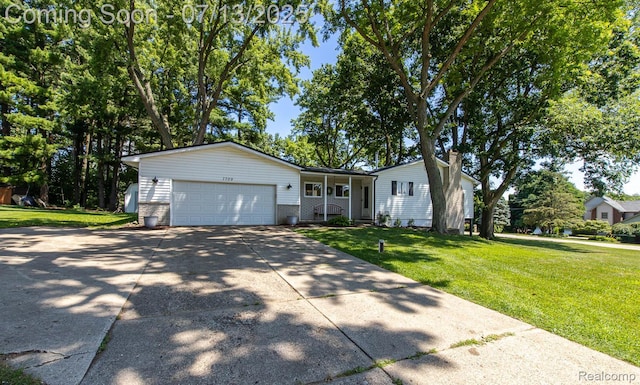 7709 Shelley Dr, Clarkston, MI 48348 - ranch-style house with a front lawn, an attached garage, concrete driveway, brick siding, and covered porch