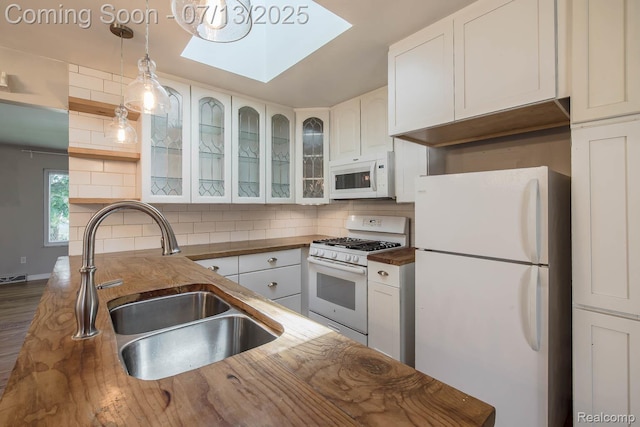 7709 Shelley Dr, Clarkston, MI 48348 - kitchen with white appliances, butcher block counters, a skylight, backsplash, and open shelves