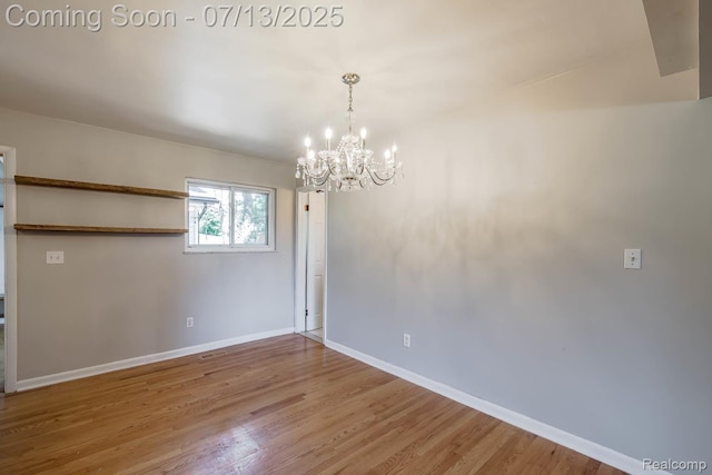 7709 Shelley Dr, Clarkston, MI 48348 - spare room with a chandelier and wood finished floors