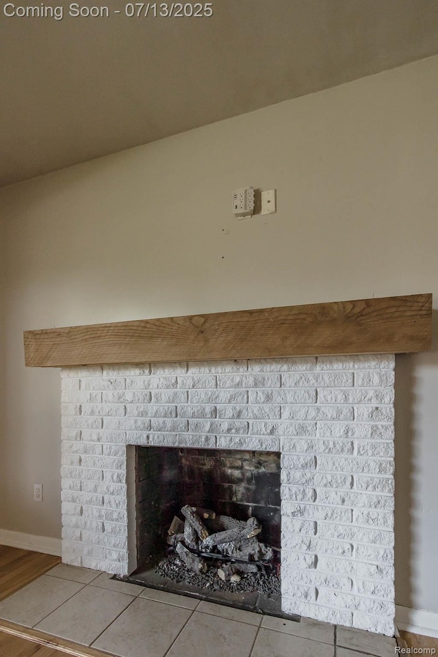 7709 Shelley Dr, Clarkston, MI 48348 - detailed view of a brick fireplace and wood finished floors