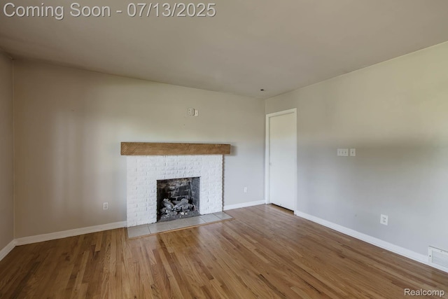 7709 Shelley Dr, Clarkston, MI 48348 - unfurnished living room with wood finished floors and a fireplace