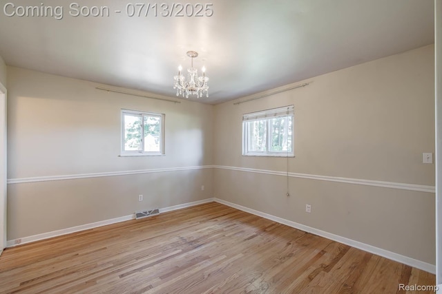 7709 Shelley Dr, Clarkston, MI 48348 - unfurnished room featuring a chandelier, plenty of natural light, and wood finished floors