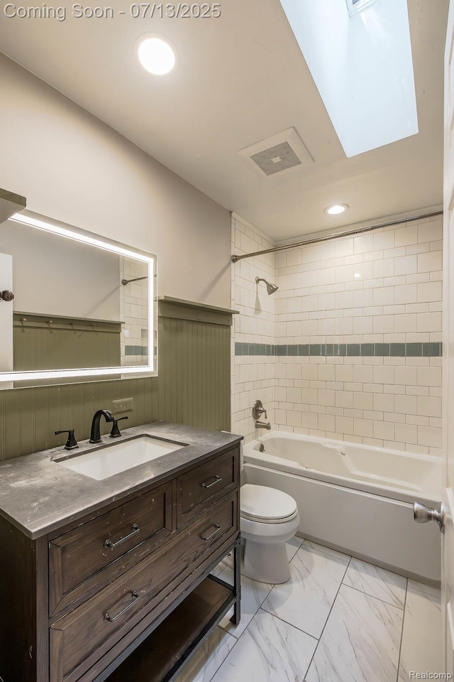 7709 Shelley Dr, Clarkston, MI 48348 - bathroom with vanity, marble look tiles, bathing tub / shower combination, recessed lighting, and wainscoting
