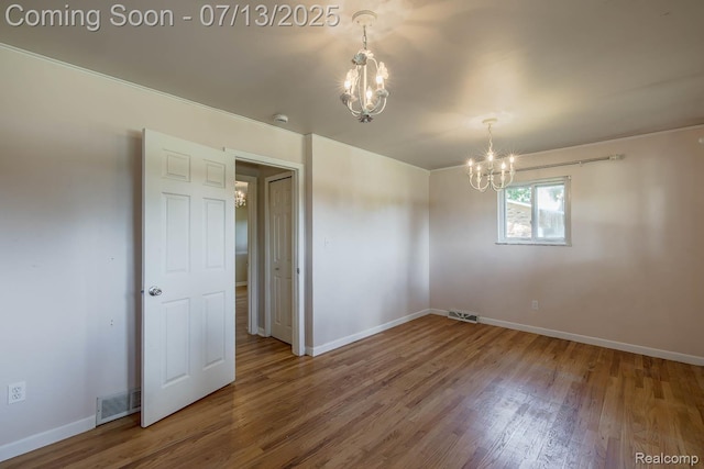 7709 Shelley Dr, Clarkston, MI 48348 - unfurnished room with a chandelier, wood finished floors, and a smoke detector