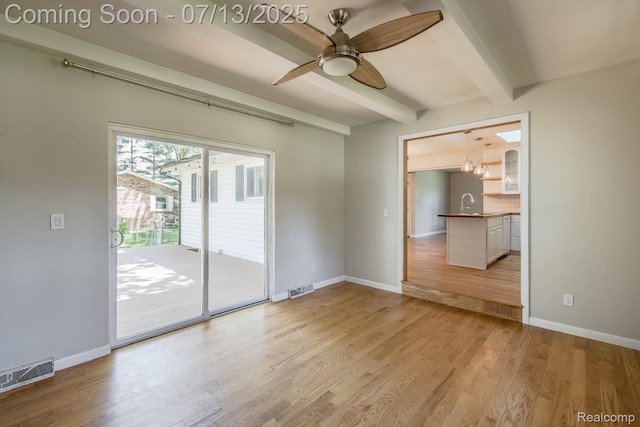 7709 Shelley Dr, Clarkston, MI 48348 - spare room featuring beam ceiling, light wood-style floors, and ceiling fan