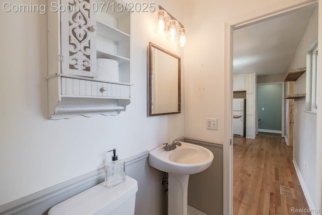 7709 Shelley Dr, Clarkston, MI 48348 - half bathroom with wood finished floors and toilet