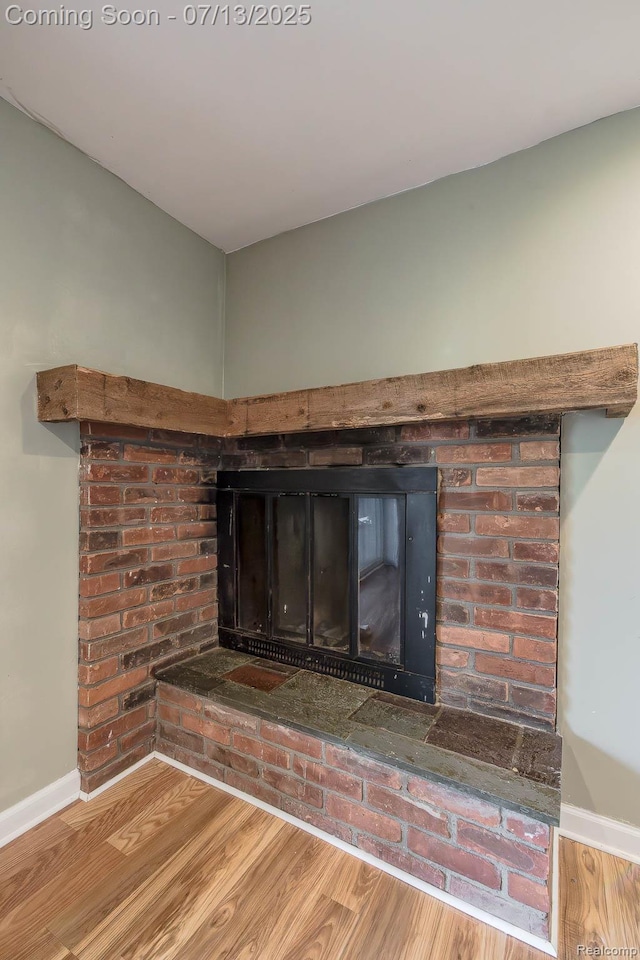 7709 Shelley Dr, Clarkston, MI 48348 - detailed view of a brick fireplace and wood finished floors