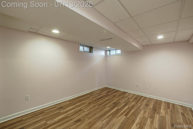 7709 Shelley Dr, Clarkston, MI 48348 - below grade area with a drop ceiling and wood finished floors