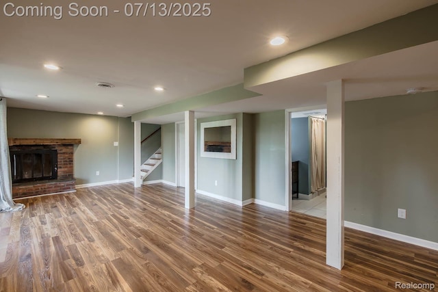 7709 Shelley Dr, Clarkston, MI 48348 - unfurnished living room featuring wood finished floors, a fireplace, stairway, and recessed lighting