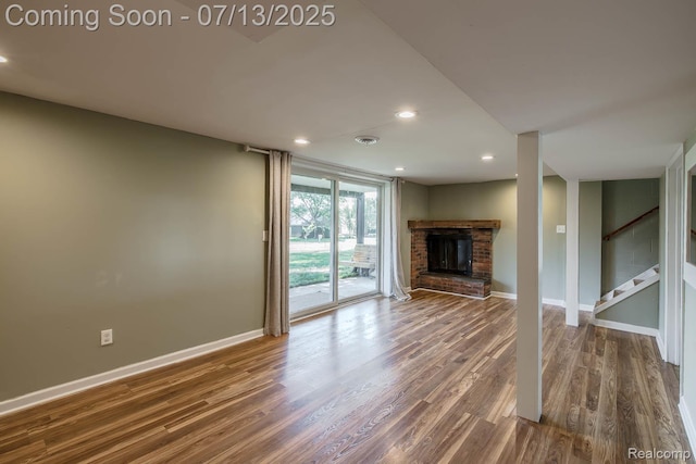 7709 Shelley Dr, Clarkston, MI 48348 - unfurnished living room with wood finished floors, a fireplace, recessed lighting, and stairway