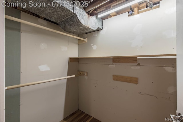 7709 Shelley Dr, Clarkston, MI 48348 - spacious closet with dark wood-style floors