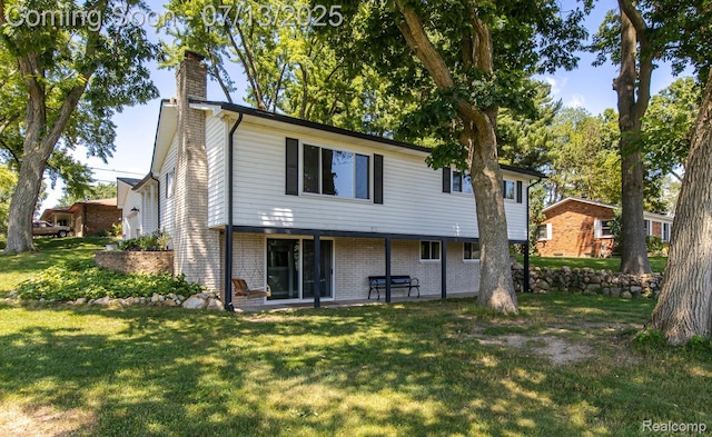 7709 Shelley Dr, Clarkston, MI 48348 - rear view of house featuring a chimney, a lawn, a patio, and brick siding