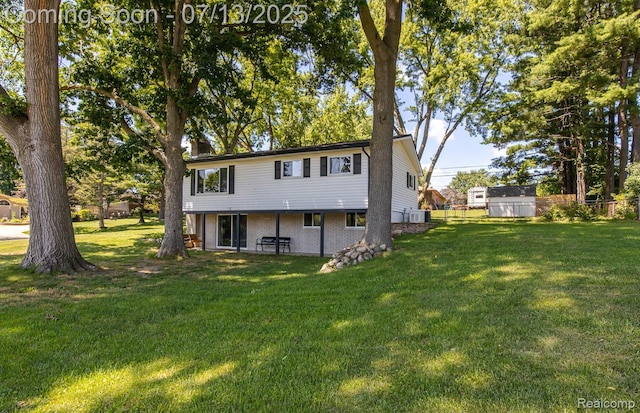 7709 Shelley Dr, Clarkston, MI 48348 - rear view of property featuring a yard and brick siding