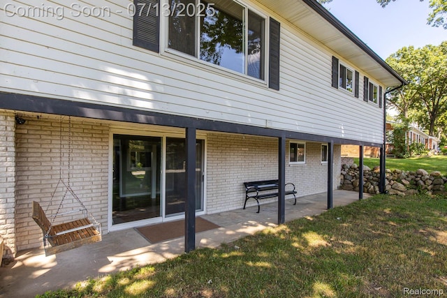 7709 Shelley Dr, Clarkston, MI 48348 - rear view of property featuring a patio area, a lawn, and brick siding