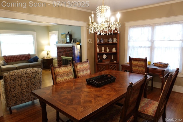 341 W Oakridge St W, Ferndale, MI 48220 - dining space featuring crown molding, wood finished floors, a chandelier, plenty of natural light, and a fireplace