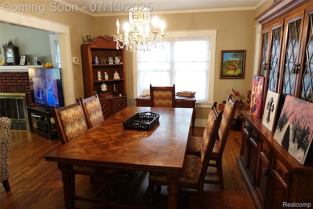 341 W Oakridge St W, Ferndale, MI 48220 - dining space featuring dark wood finished floors, ornamental molding, a chandelier, and a brick fireplace