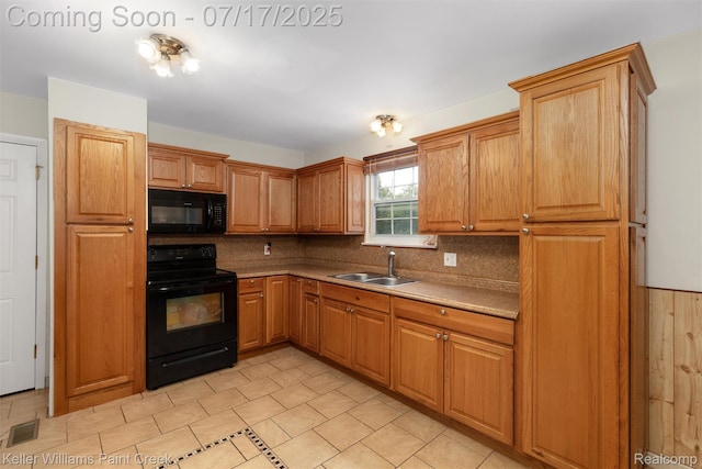 1046 Stonehenge Rd, Flint, MI 48532 - kitchen with black appliances, decorative backsplash, light countertops, and brown cabinetry