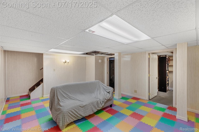 1046 Stonehenge Rd, Flint, MI 48532 - finished below grade area featuring a paneled ceiling and stairway