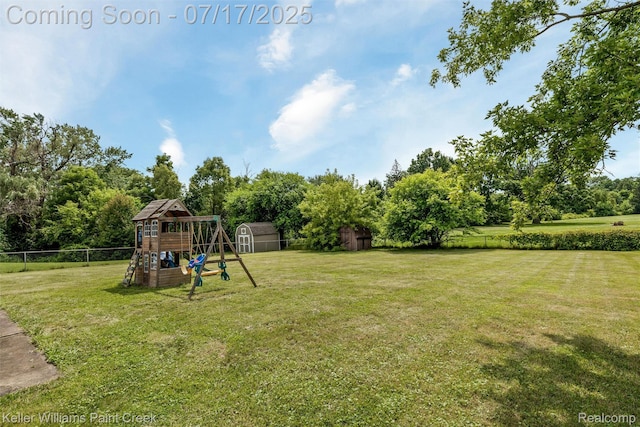 1046 Stonehenge Rd, Flint, MI 48532 - view of yard featuring a playground, a storage shed, and view of scattered trees