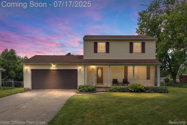 1046 Stonehenge Rd, Flint, MI 48532 - traditional-style house with covered porch, a garage, and concrete driveway