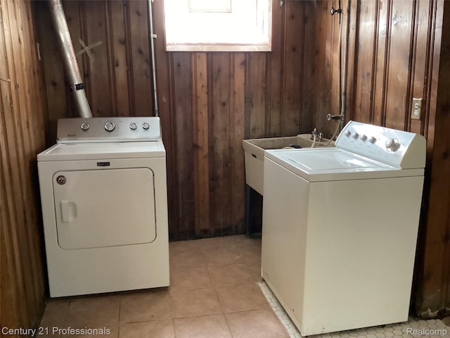 15451 Prest St, Detroit, MI 48227 - laundry room featuring washer and clothes dryer, wood walls, and light tile patterned floors