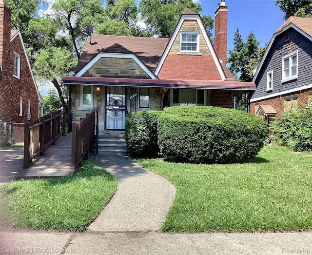 15451 Prest St, Detroit, MI 48227 - tudor-style house featuring a chimney and brick siding